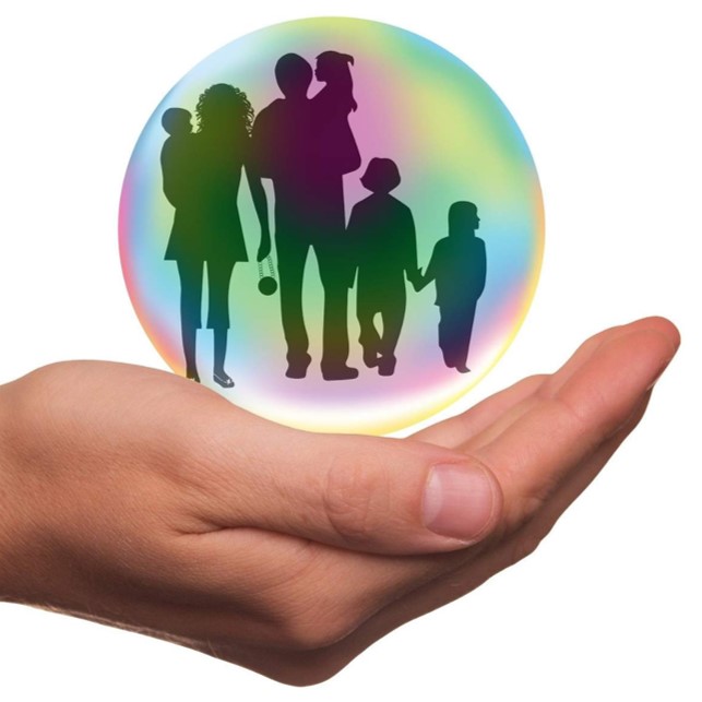 Hand holding a family in a bubble.